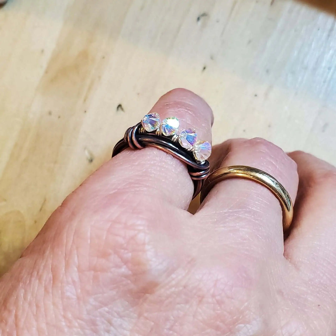 Handmade Copper Multi Wire Wrapped Super Sparkly Bling Ring worn on a hand with crystal-clear rhinestones reflecting light.