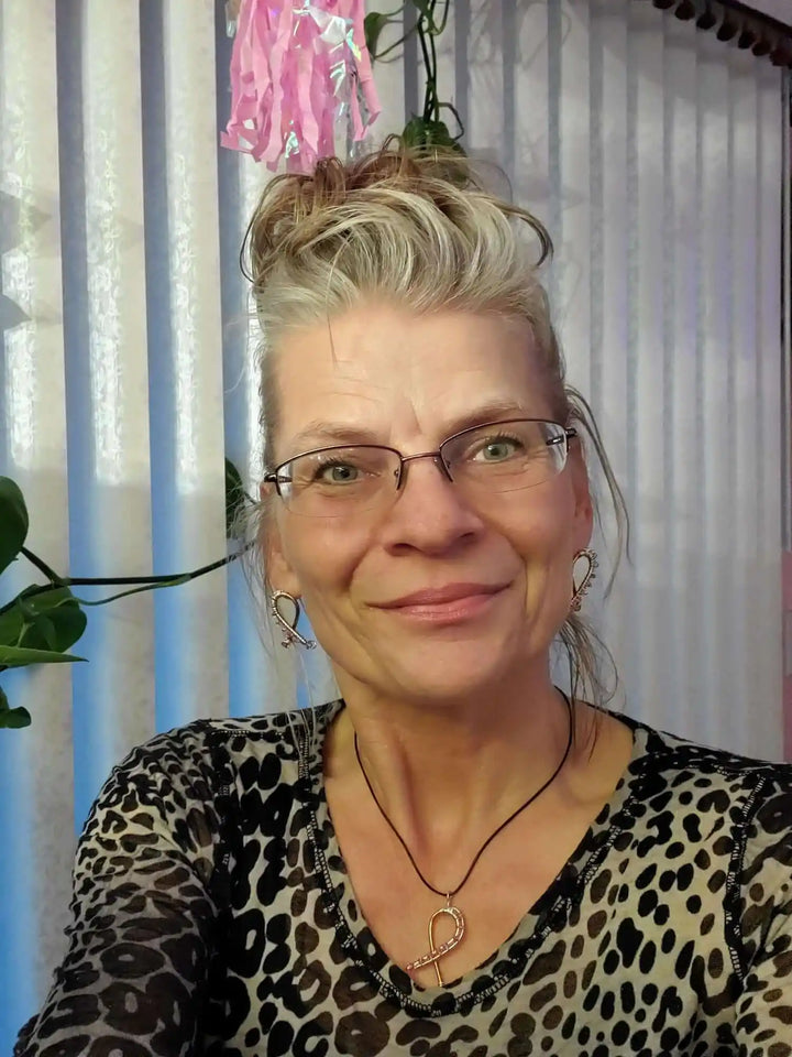 Handmade Copper Silver Pink Crystal Ribbon Jewelry Set worn by a smiling woman with glasses and a leopard print top.
