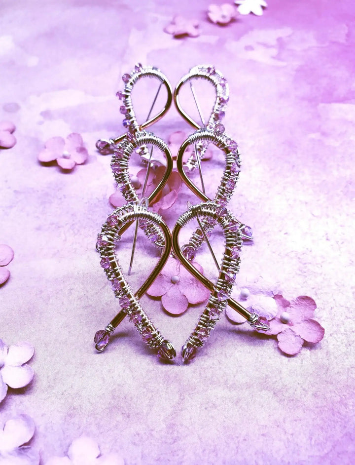 Handmade Copper Silver Pink Crystal Ribbon Jewelry Set displayed on a purple background with decorative flowers.