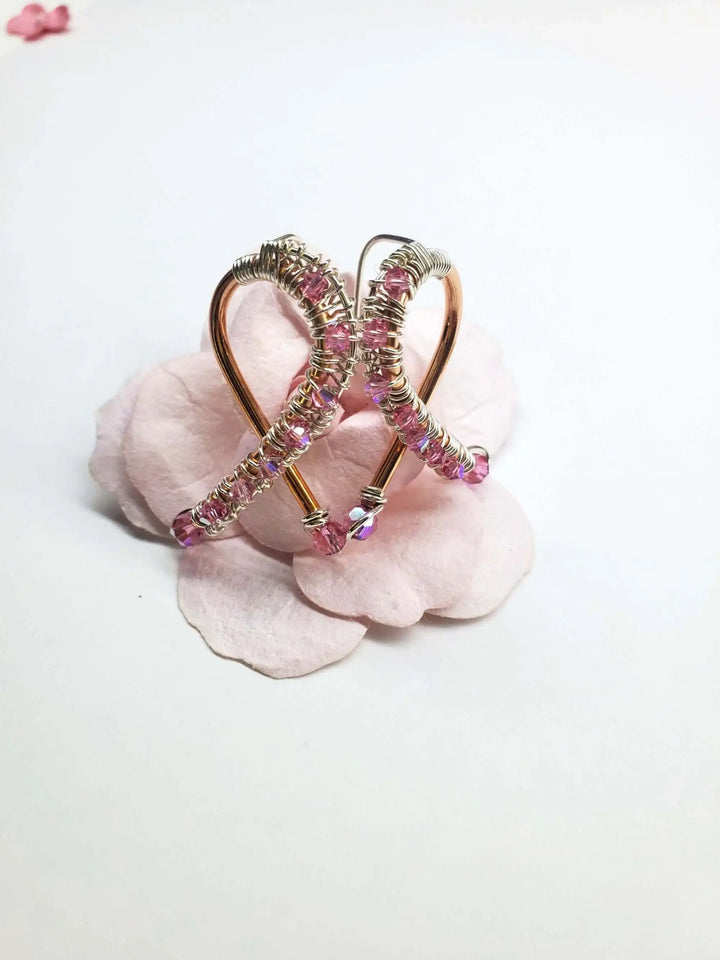 Handmade Copper Silver Pink Crystal Ribbon Jewelry Set featuring elegant earrings on a delicate pink flower background.