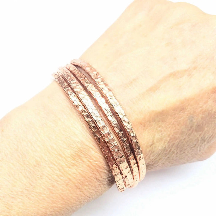 Copper Full Overlap Inter Locking Bangle Set worn on wrist, showcasing its unique design and beautiful shine.