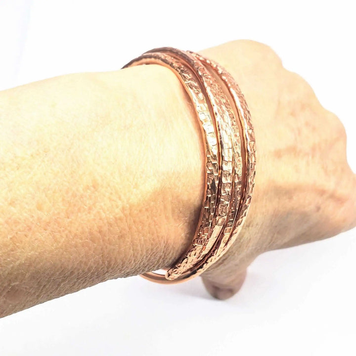 Copper Full Overlap Inter Locking Bangle Set showcasing the unique design on a wrist, creating a stunning optical illusion.