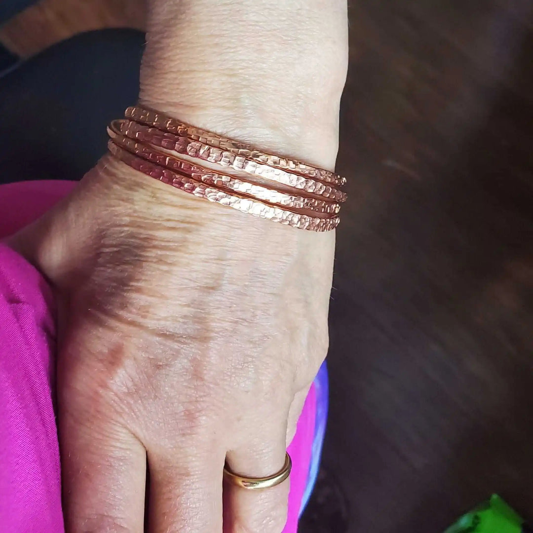 Copper Full Overlap Inter Locking Bangle Set worn on a wrist showcasing the unique 3D optical illusion design.
