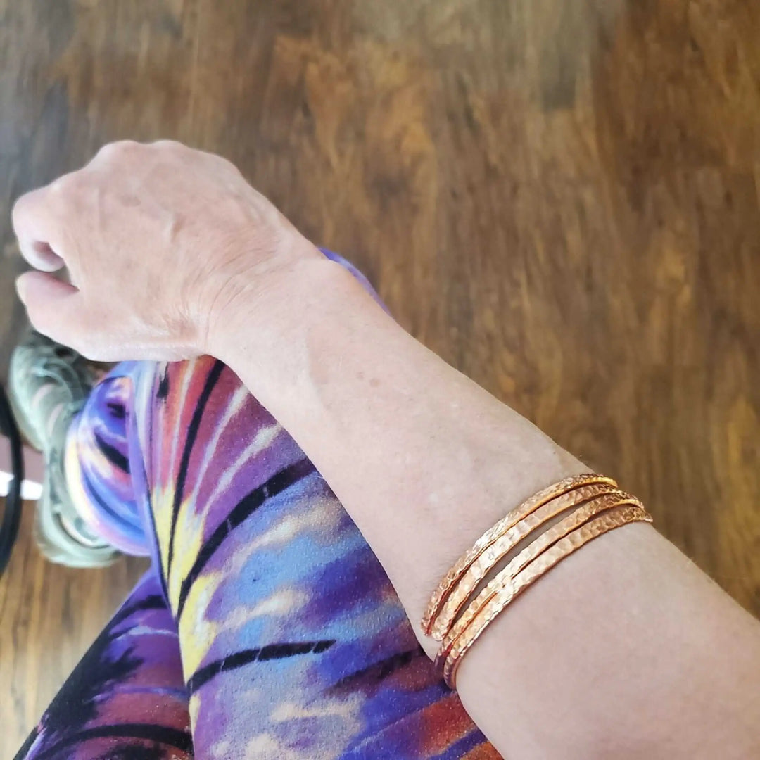 Copper Full Overlap Inter Locking Bangle Set worn on a wrist, showcasing its craftsmanship and optical illusion.