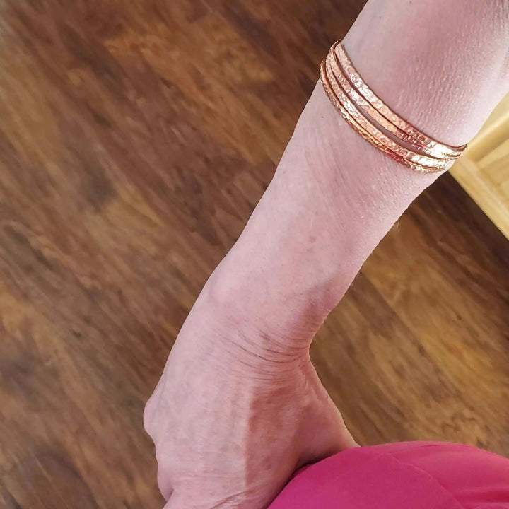 Copper Full Overlap Inter Locking Bangle Set worn on wrist, showcasing its unique design and elegant finish.