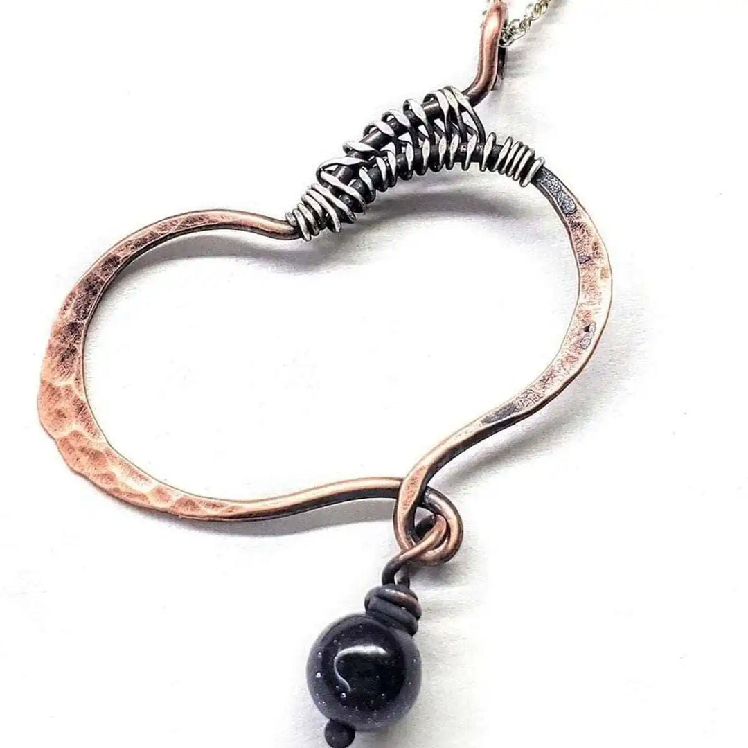 Hammered Copper Butterfly Wing Child Abuse Survivor Necklace featuring a black crystal teardrop.