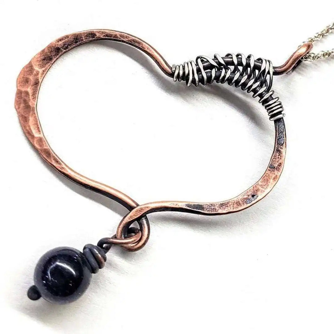 Hammered Copper Butterfly Wing Child Abuse Survivor Necklace with black bead detail.