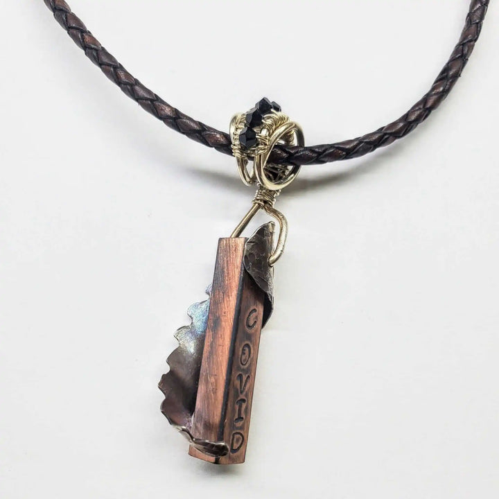 Sculpted Memorial Angelwing Necklace - Limited Edition featuring a silver angel wing pendant on a braided leather cord.