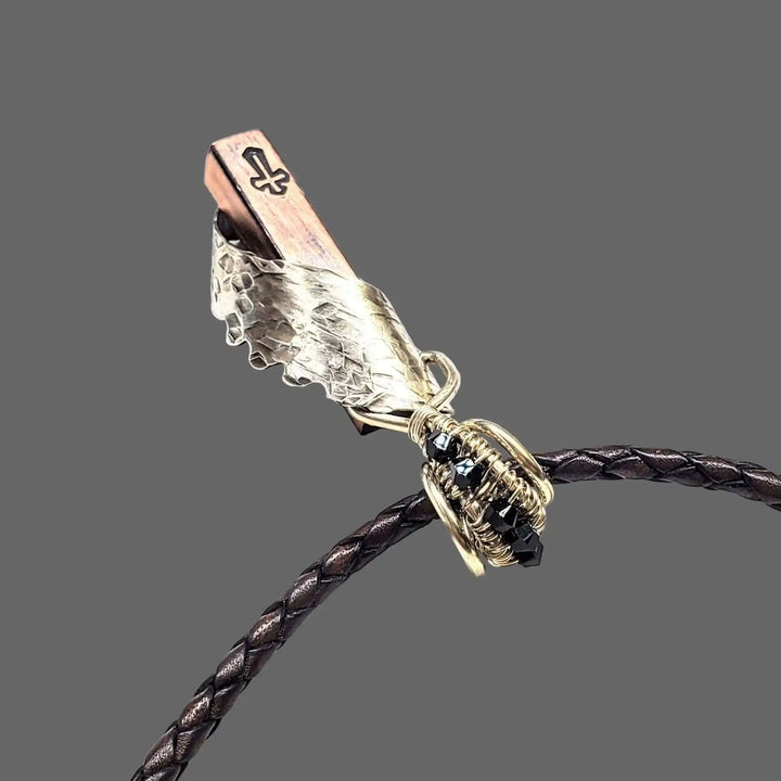 Sculpted Memorial Angelwing Necklace - Limited Edition showcasing a silver wing pendant on a braided leather cord.