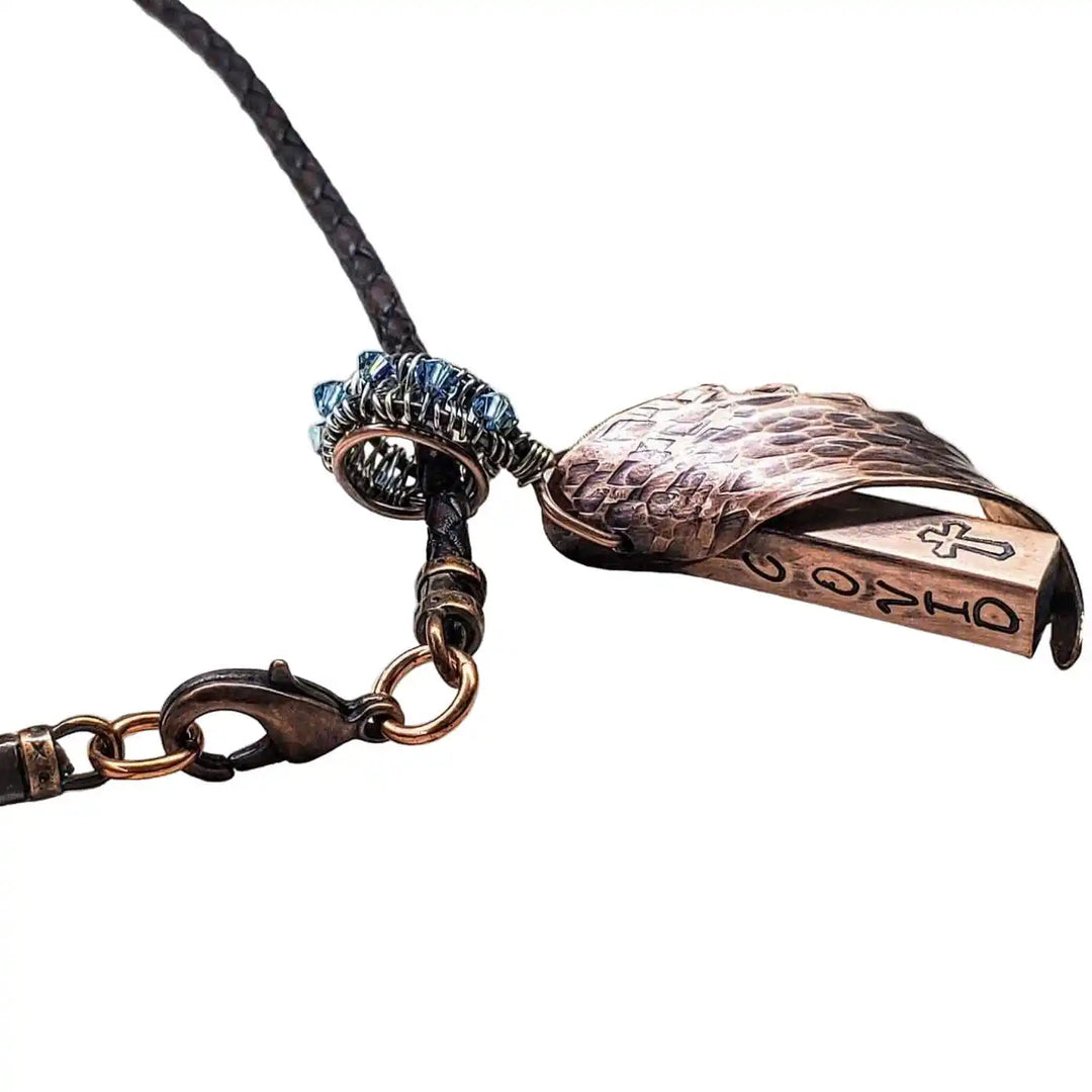 Sculpted Copper Angelwing Crystal Birthstone Necklace featuring a detailed copper angel wing pendant on a braided cord.