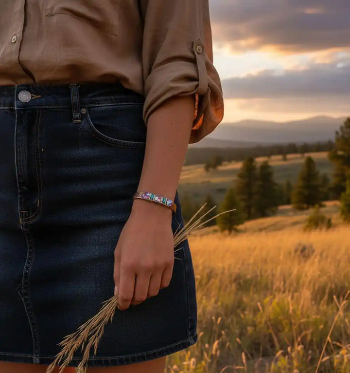 Handmade Copper Turquoise Crystal Spike Cuff worn in a sunset landscape, showcasing beautiful artisan jewelry.