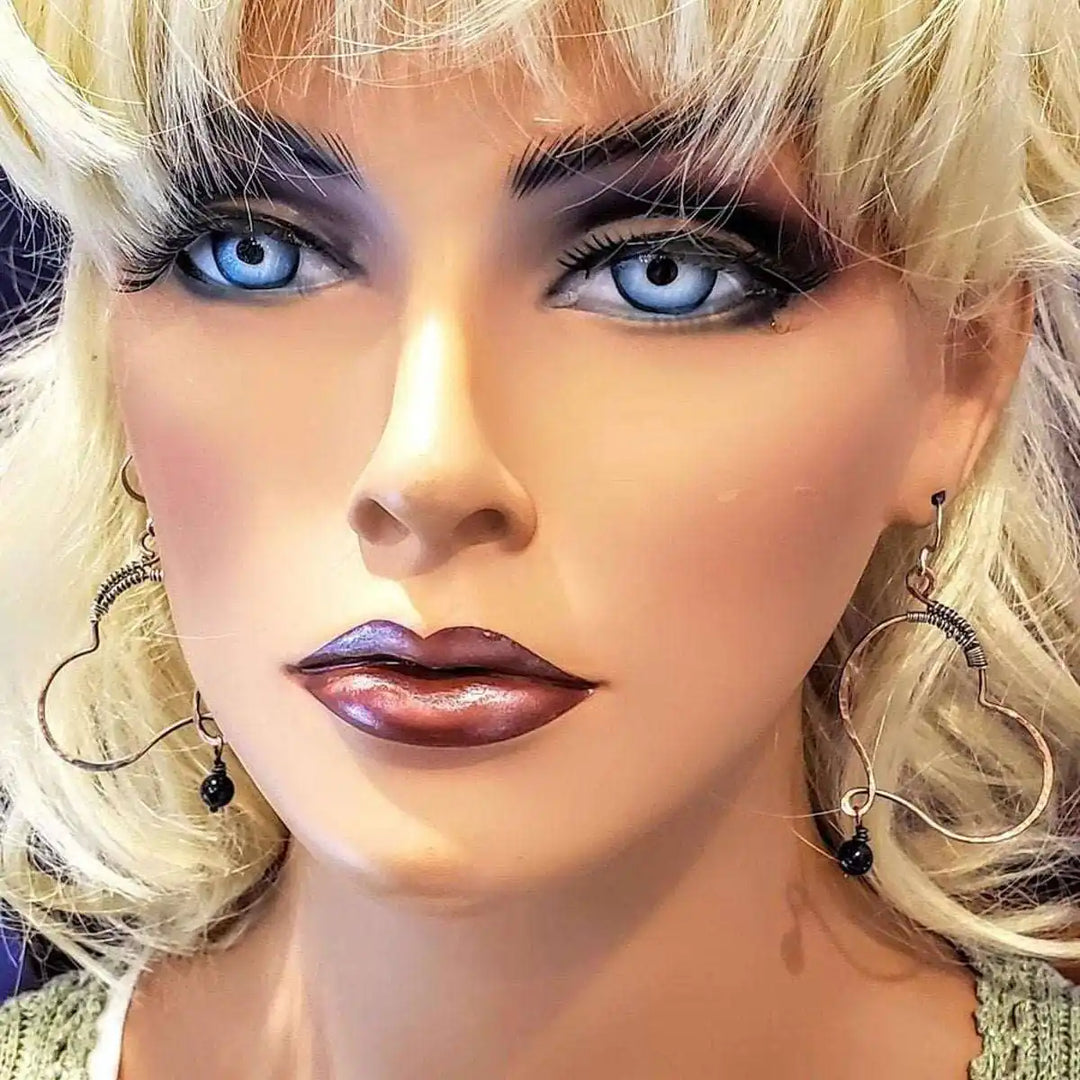 Sculpted Copper Butterfly Wing Abuse Survivor Earrings displayed on a mannequin with blonde hair and blue eyes.