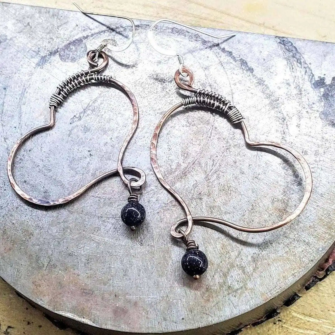 Sculpted Copper Butterfly Wing Abuse Survivor Earrings with black dangle beads and hammered texture.
