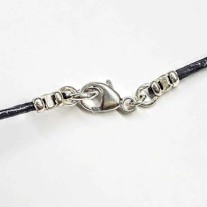 Close-up view of the clasp and detailing of the Sculpted Silver Butterfly Wing Child Abuse Survivor Necklace.