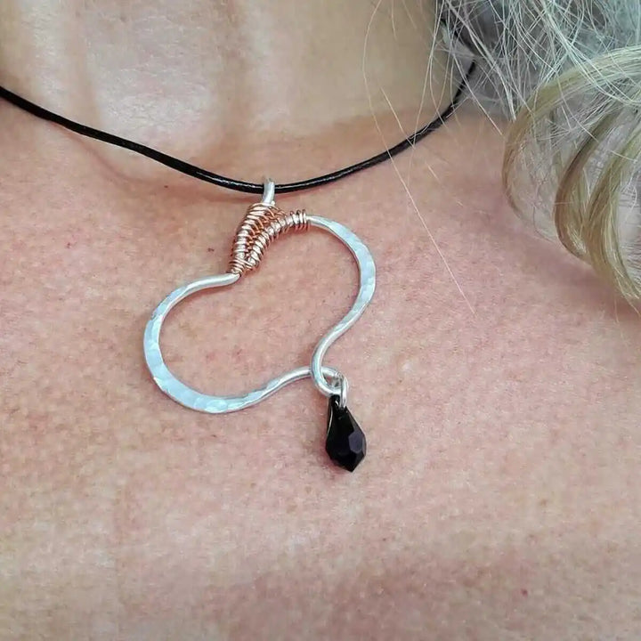 Sculpted Silver Butterfly Wing Child Abuse Survivor Necklace displayed on a person, showcasing its unique design and elegance.
