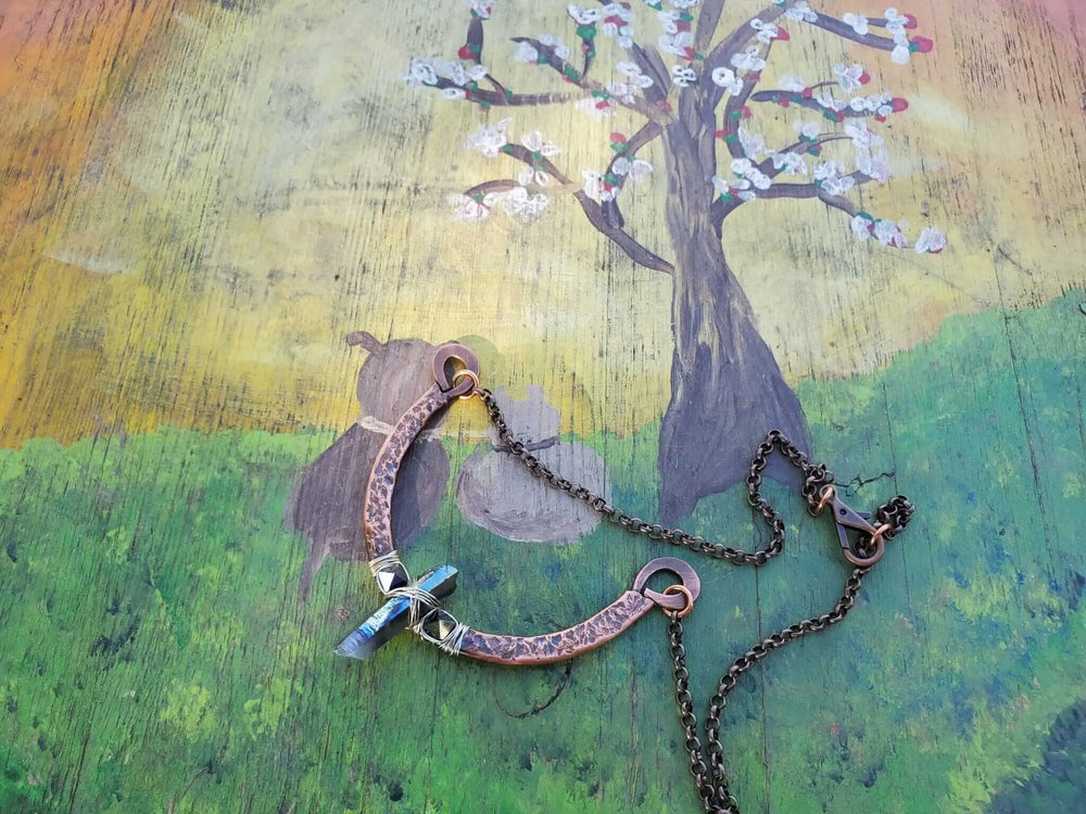 Hammered Sculpted Wire Wrapped Fight For The Truth Necklace showcased on a colorful background with artistic tree design.