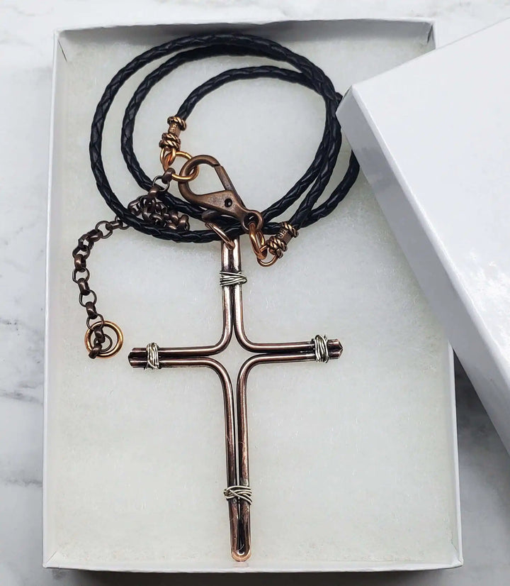 Handmade Large Copper and Silver Wire Cross Necklace for Men displayed in a gift box with braided cord.