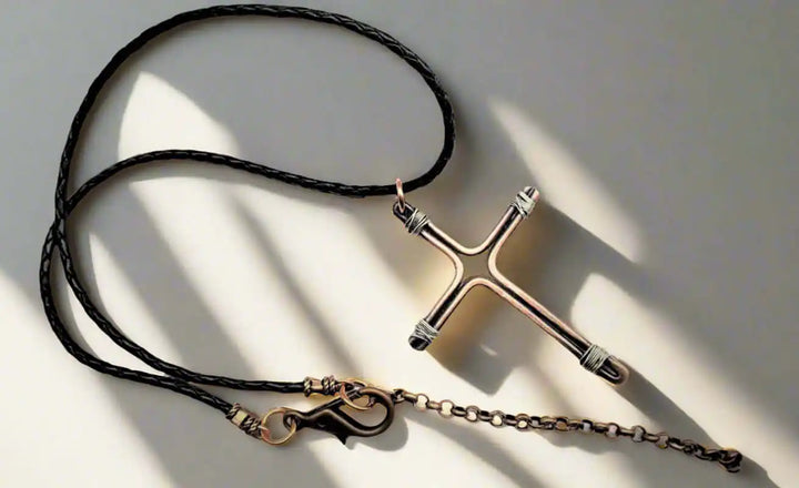 Handmade Large Copper and Silver Wire Cross Necklace for Men on a braided necklace, highlighting its artisan craftsmanship.
