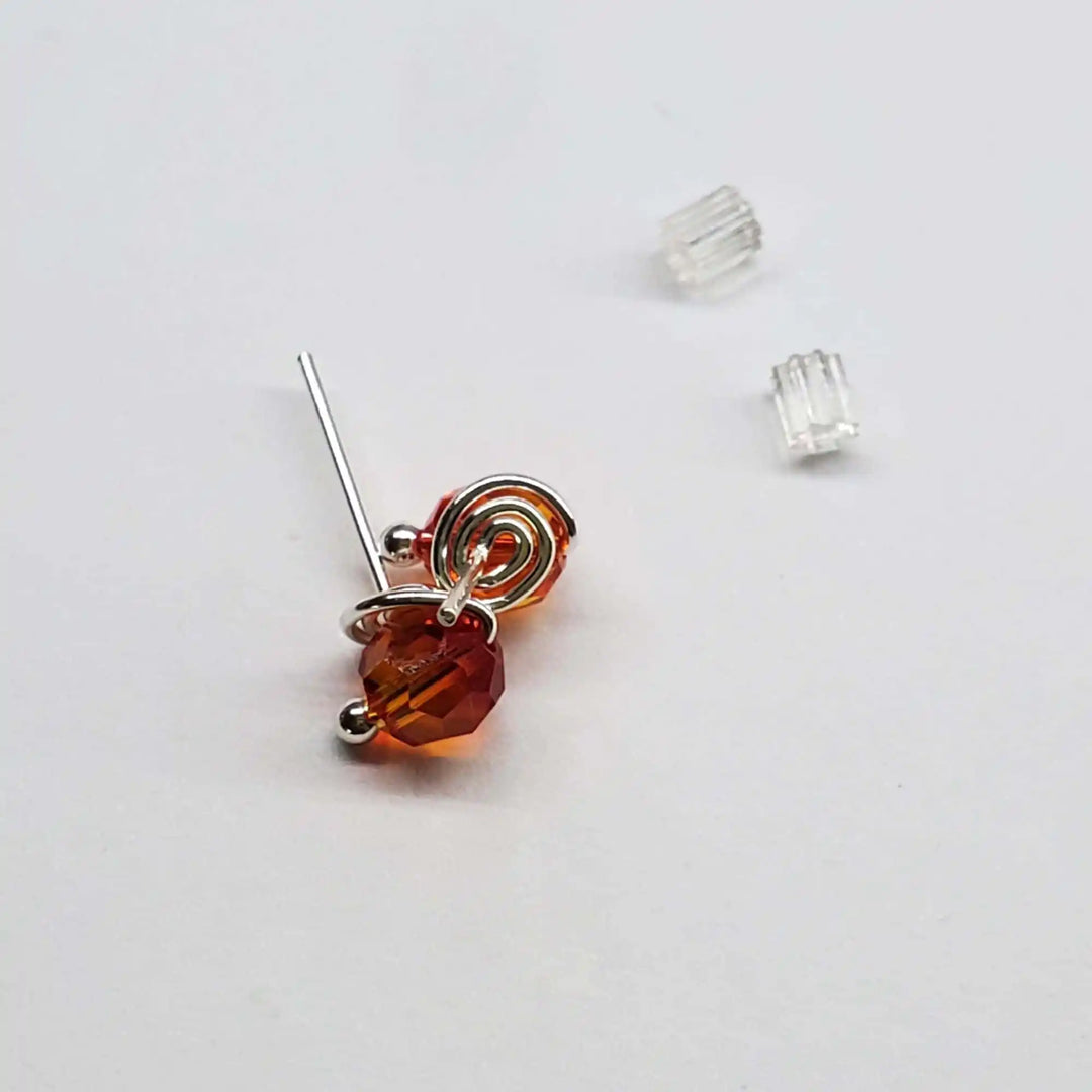Handmade 6mm Silver Spiral Crystal Stud Earrings with orange Swarovski crystal and silver spiral detail.