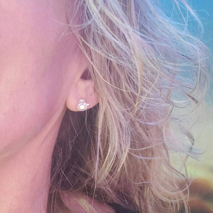 Close-up of a woman wearing Handmade 6mm Silver Spiral Crystal Stud Earrings, showcasing Swarovski crystals.