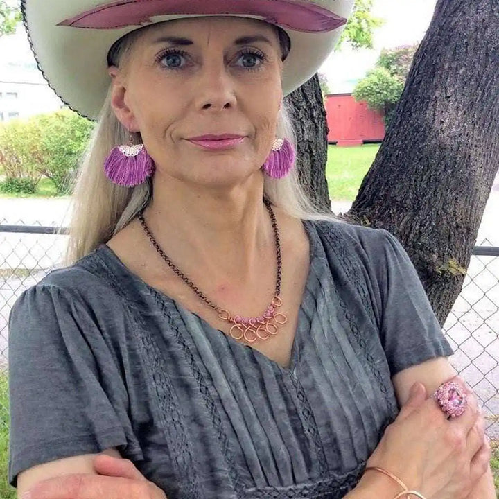 Handmade Sculpted Copper Teardrop Bangle showcased on a stylish woman with cowboy hat and vibrant jewelry.