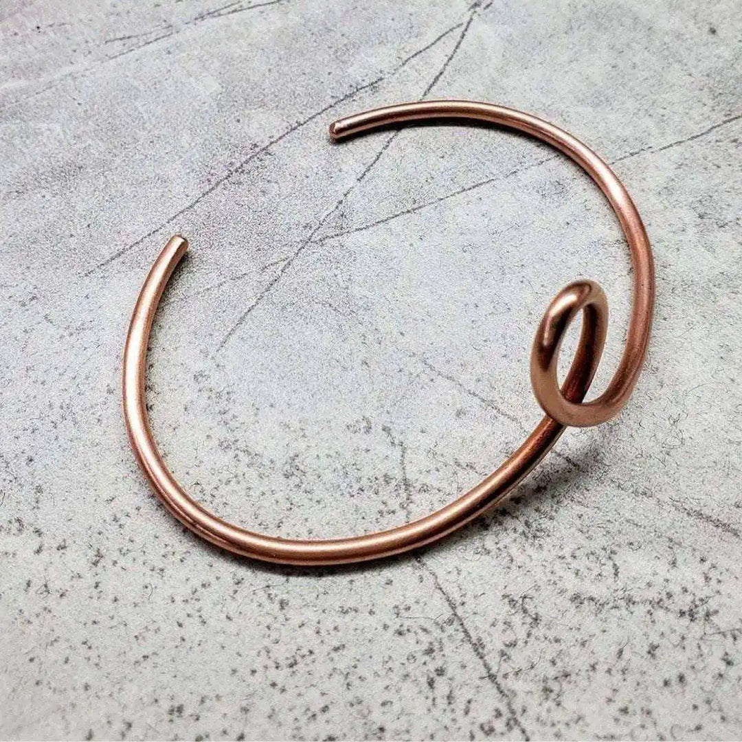 Handmade Sculpted Copper Teardrop Bangle featuring a graceful teardrop shape, crafted from sturdy copper wire.