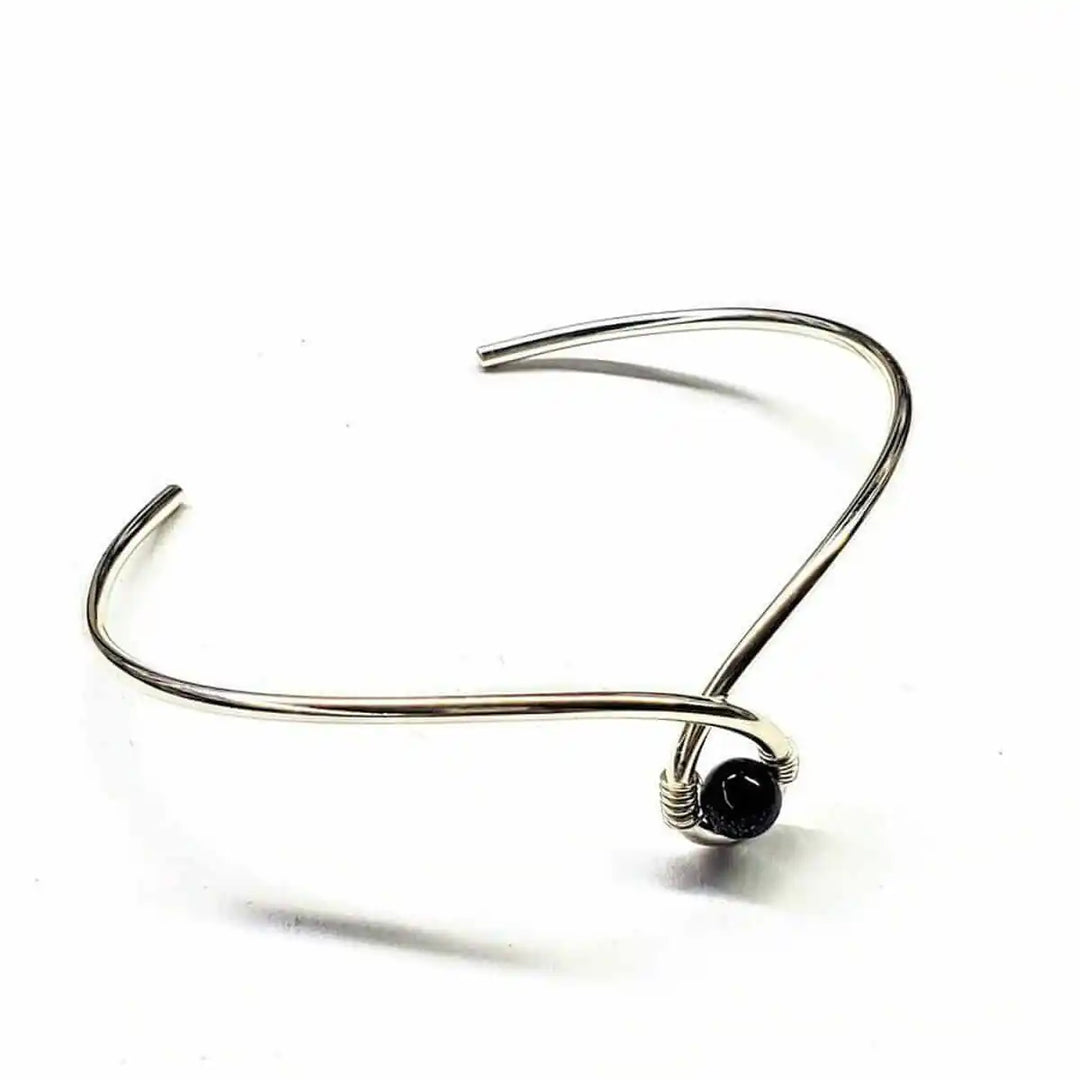 Silver Blue Bead Child Abuse Awareness Ribbon Bangle features a stylish design with a blue sandstone bead.
