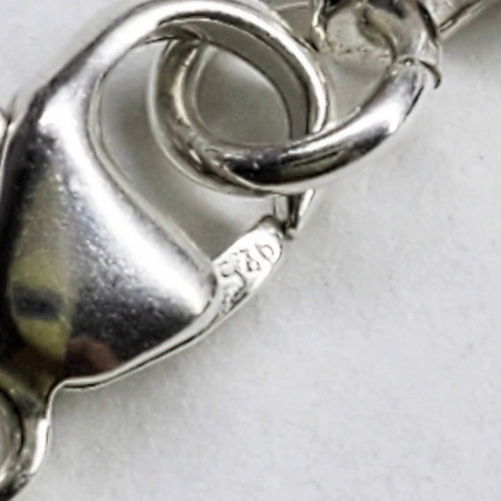 Close-up of the clasp detail on a handmade silver crystal pineapple leather necklace.