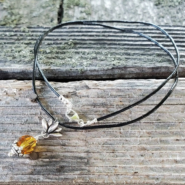 Handmade silver crystal pineapple leather necklace featuring a yellow Swarovski crystal pendant on a black cord.