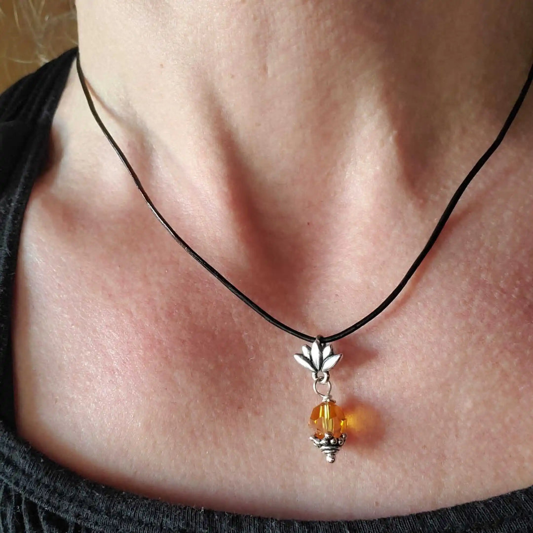 Handmade Silver Crystal Pineapple Leather Necklace worn with a black leather cord, featuring a silver pineapple charm and yellow crystal.