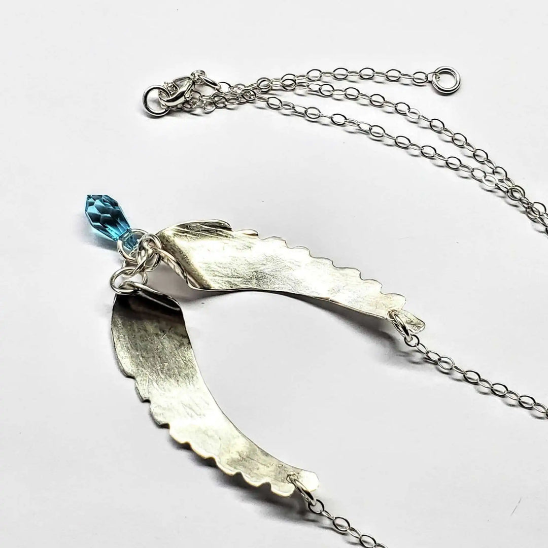 Handmade Silver Forged Sculpted Angel Wings Necklace featuring a Swarovski crystal teardrop.