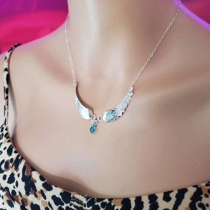 Handmade Silver Forged Sculpted Angel Wings Necklace displayed on a mannequin, featuring Swarovski crystal teardrop accent.