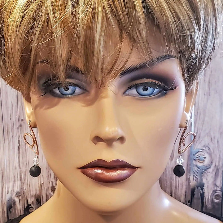 Embossed Copper Butterfly Wing Lava Rock Bead Earrings displayed on a mannequin.
