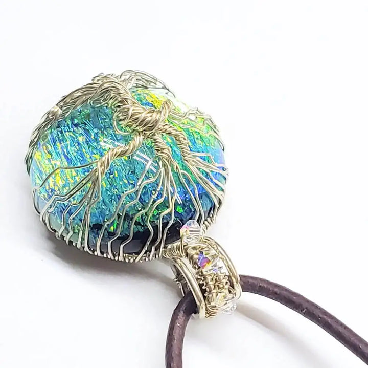 Handmade tree of life dichroic pendant necklace with vibrant colors and intricate wire wrapping.