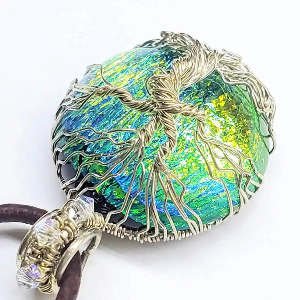 Handmade tree of life dichroic pendant necklace showcasing vibrant colors and unique wire wrapping.