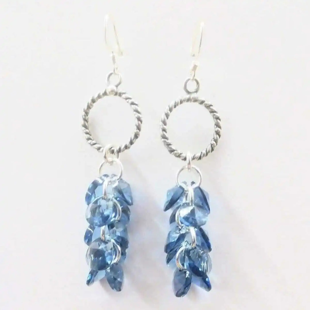 925 Silver Denim Blue Cascading Crystal Cluster Earrings featuring a stunning cluster of blue crystals and silver details.