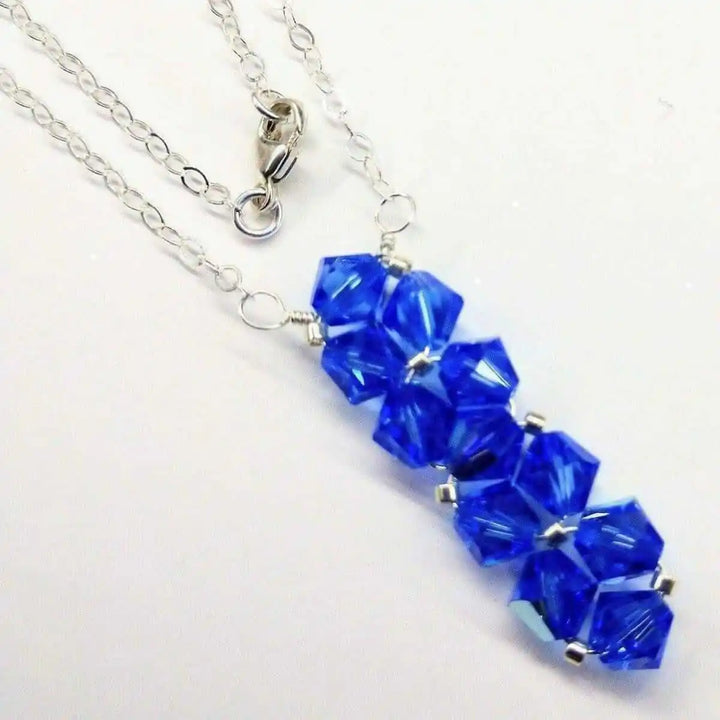 Handmade Wire Colored Woven Crystal Rock Candy Necklace featuring blue Swarovski crystal bicones on a silver chain.