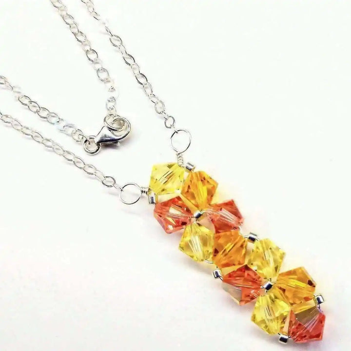 Handmade Wire Colored Woven Crystal Rock Candy Necklace featuring sparkling yellow and orange Swarovski crystals.