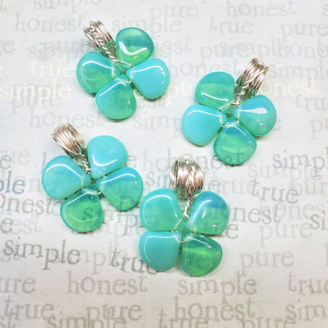 Mint green beaded clover necklace showcases four clover charms with wire wraps and Czech glass beads.