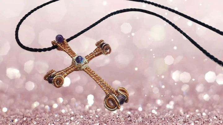 Large Wire Woven Copper Silver Amethyst Cross Necklace on a delicate cord against a sparkling background.
