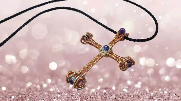 Large Wire Woven Copper Silver Amethyst Cross Necklace on a black cord against a sparkling background.