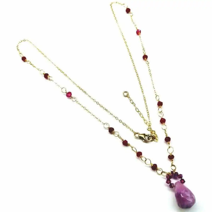 Lilac Jade Drop Gemstone Wire Wrapped Gold Filled Necklace showcasing a lavender drop pendant and gold chain with red gemstones.