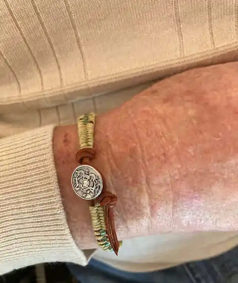 Leather Seed Bead Rattlesnake Tail Weave Bracelet worn on a wrist, showcasing intricate design and rustic charm.