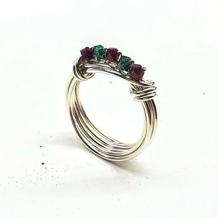 Limited edition 2026 silver wire wrapped Christmas ring featuring Swarovski crystals in red and green.
