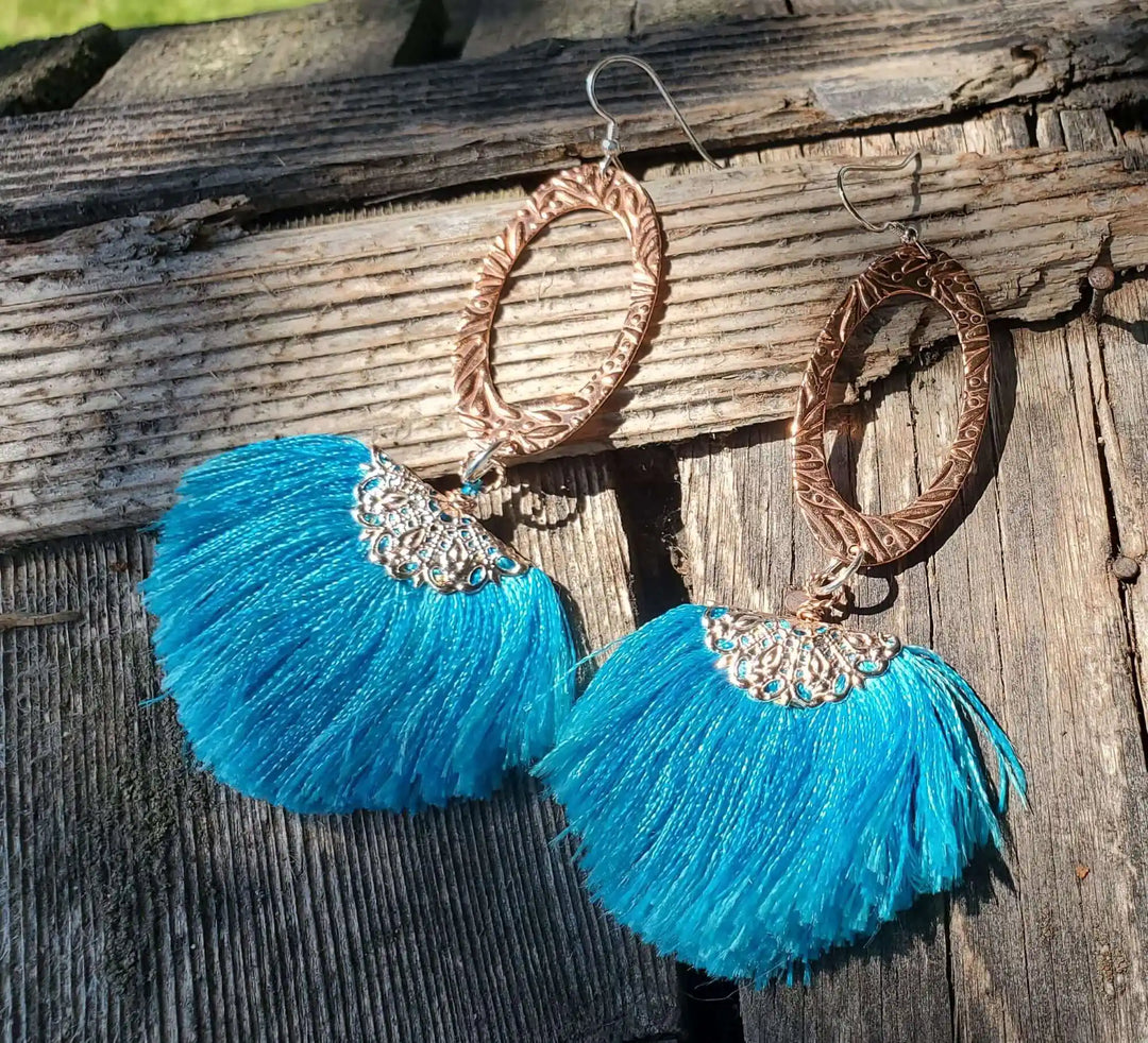 Long Copper Embossed Aqua Brushed Silk Fan Tassel Earrings with vibrant blue tassels and intricate metalwork.