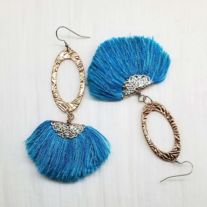Long Copper Embossed Aqua Brushed Silk Fan Tassel Earrings with intricate metalwork and bright aqua silk tassels.