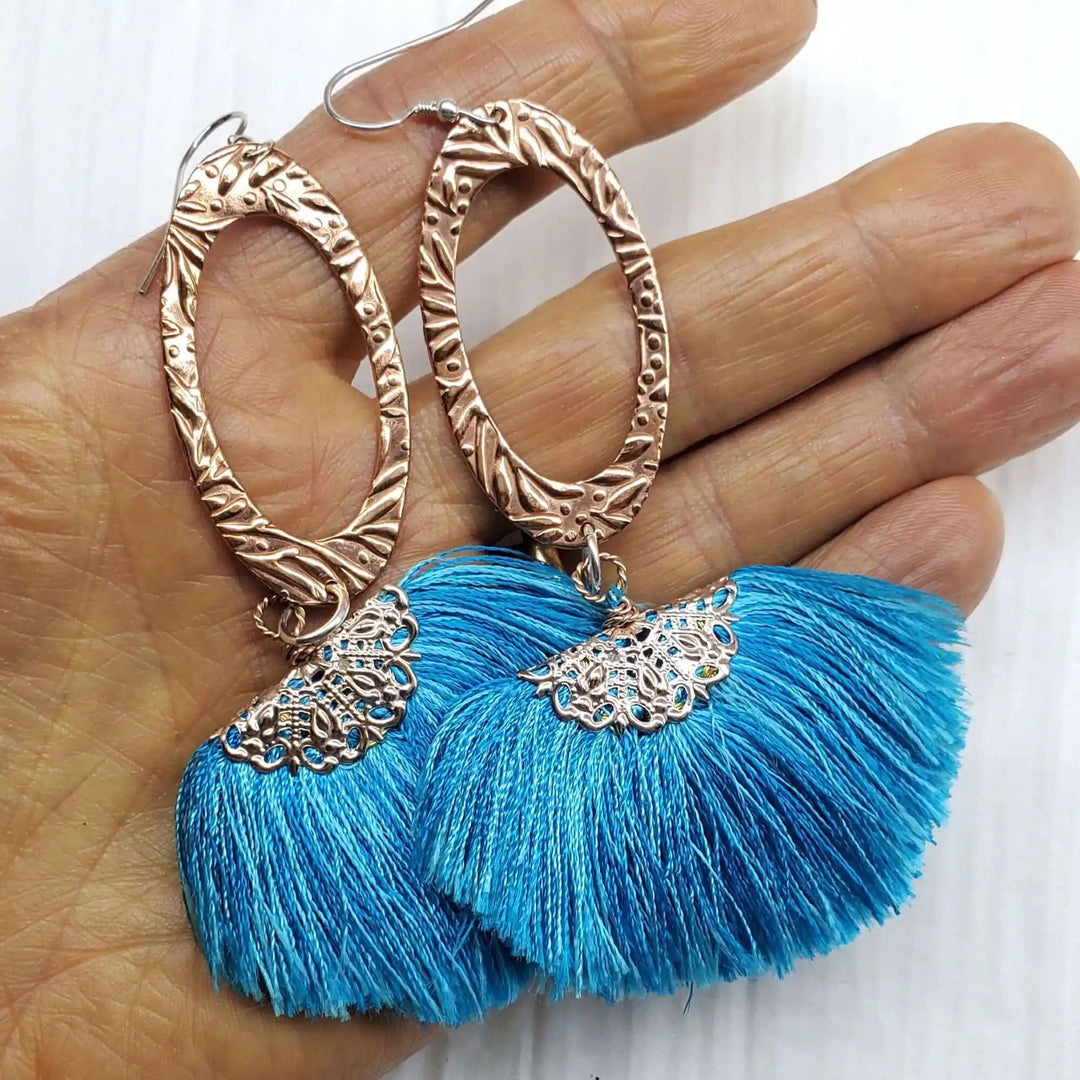 Long Copper Embossed Aqua Brushed Silk Fan Tassel Earrings with vibrant blue tassels and intricate metalwork.