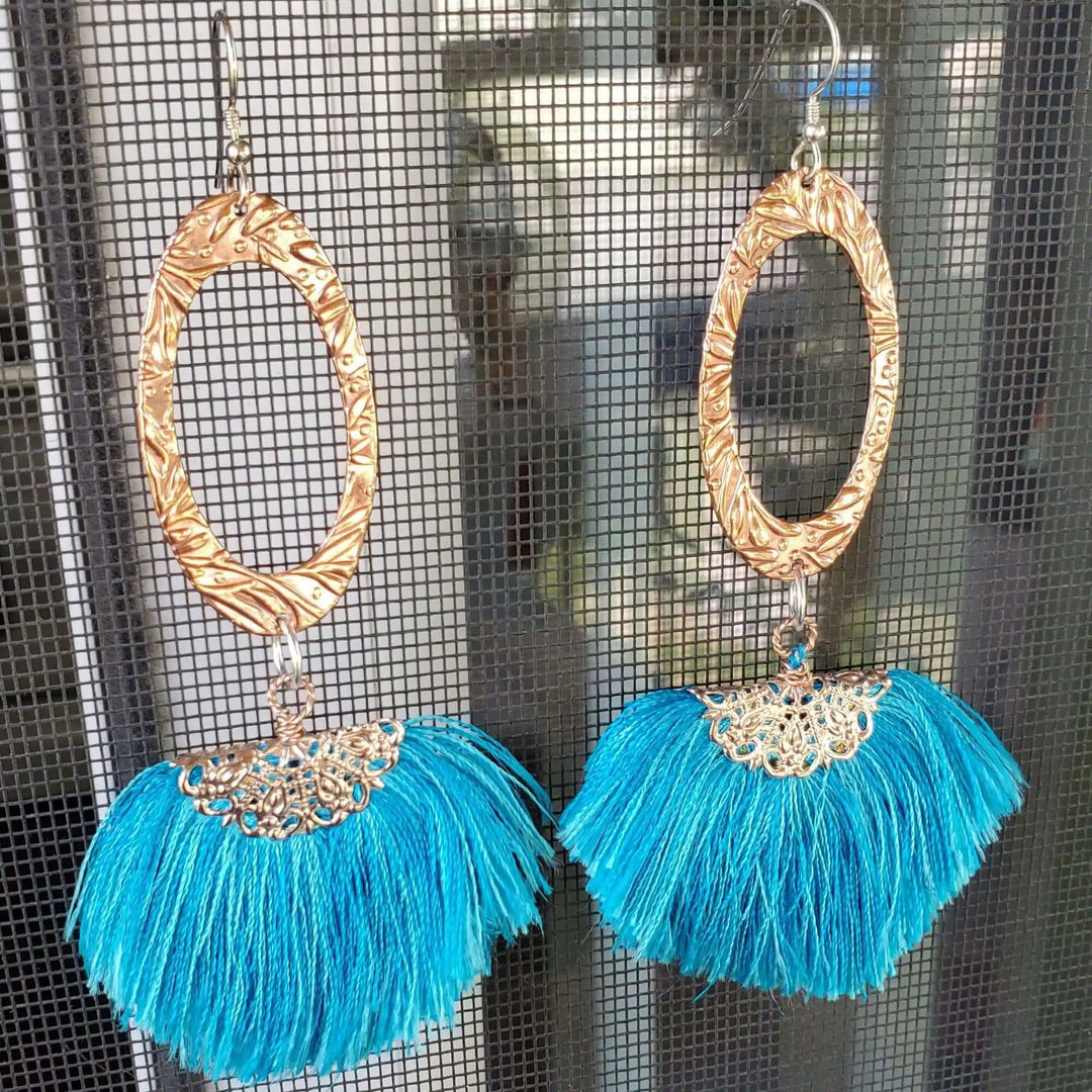 Long Copper Embossed Aqua Brushed Silk Fan Tassel Earrings showcasing vibrant aqua silk tassels and intricate metalwork.