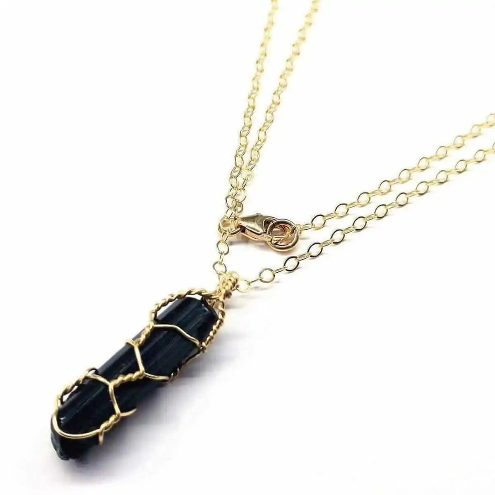 14 K Gold Filled Wire Wrapped Raw Black Tourmaline Necklace showcasing a black tourmaline pendant on a gold chain.