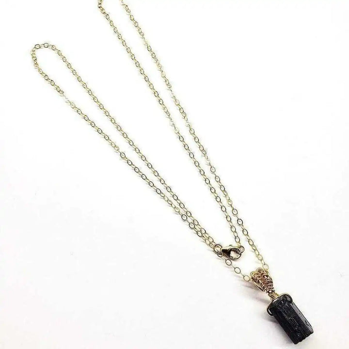Wire Wrapped Raw Black Tourmaline Gemstone Necklace on a delicate chain in an elegant display.